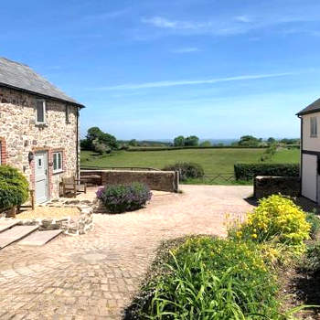 The Granary at Pentregaer Ucha, tennis court & lake.